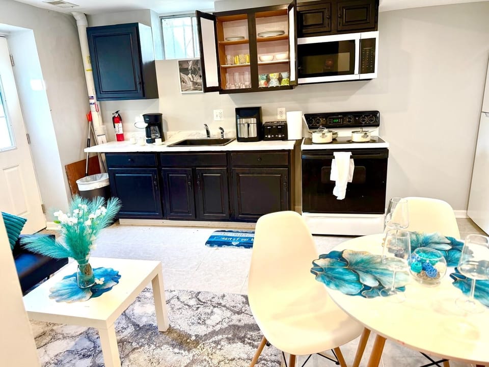 Kitchen with all utensils and fridge on the right corner 