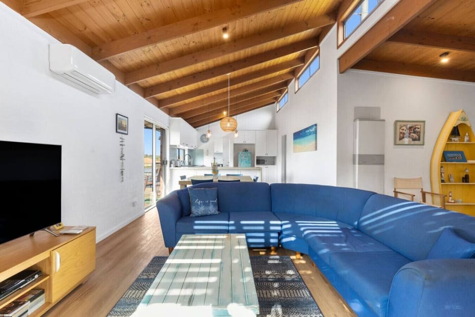 Spacious coastal living room bathed in beautiful sunlight