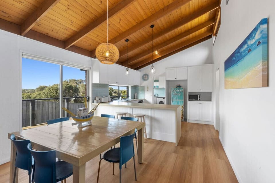 Bright beachy dining space with gorgeous timber ceiling