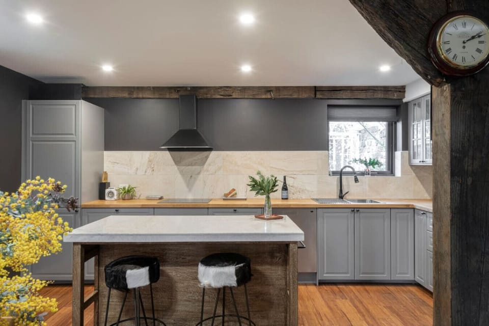 Beautiful kitchen with rustic beams and marble splashback