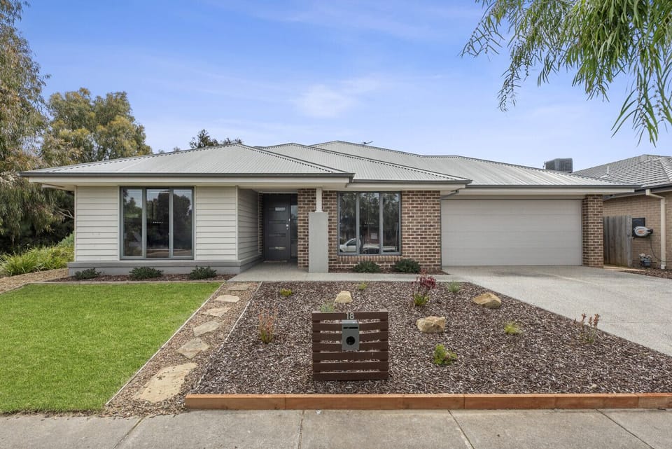 Modern home exterior with landscaped front yard and double garage