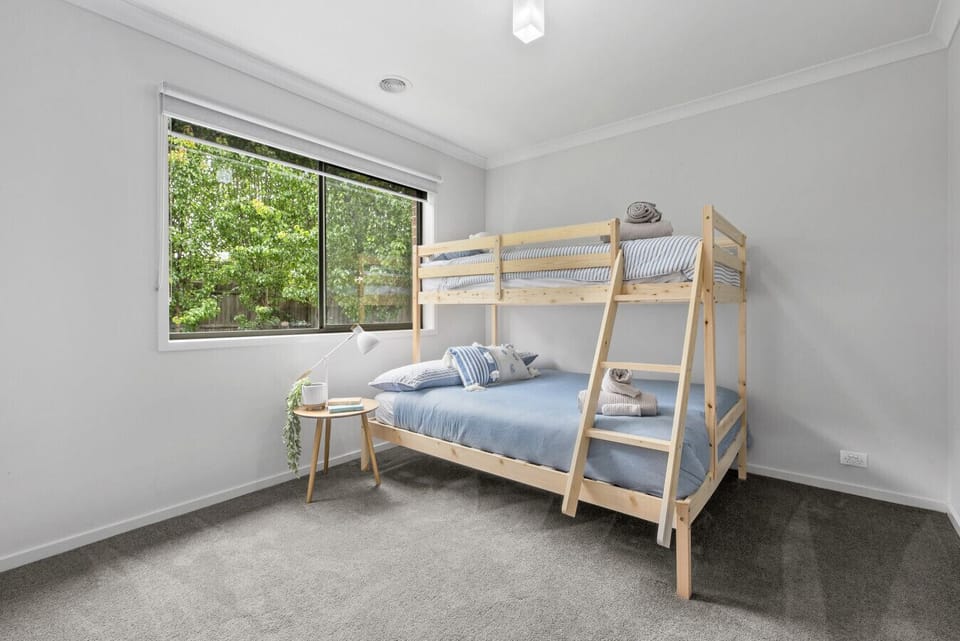 Bedroom 4: Functional bunk bedroom with natural light and comfortable sleeping space