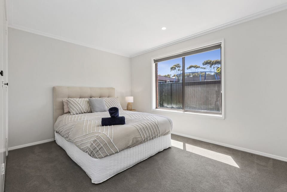 Bedroom 3: A calm and airy bedroom filled with natural light for a restful stay.