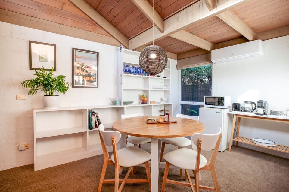 Cozy dining nook with timber accents and soft light, perfect for relaxed meals