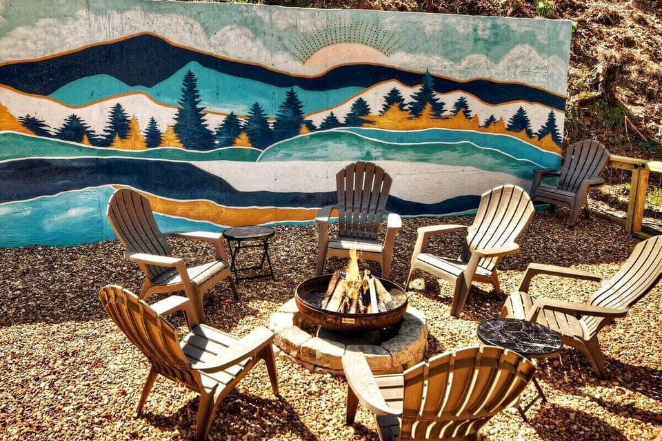 Enjoy relaxing times around the fire and custom Blue Ridge mural!