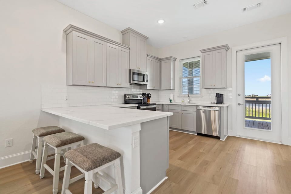 Modern, fully equipped kitchen with bar seating—perfect for cooking and gathering together.