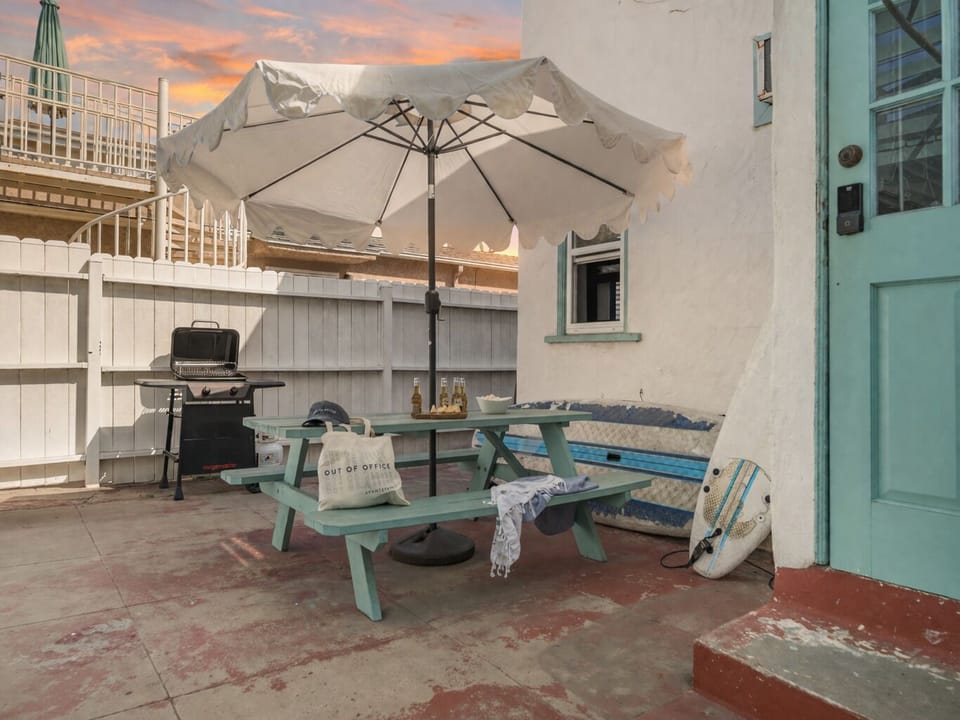 Shared patio with a BBQ grill and al fresco dining table.