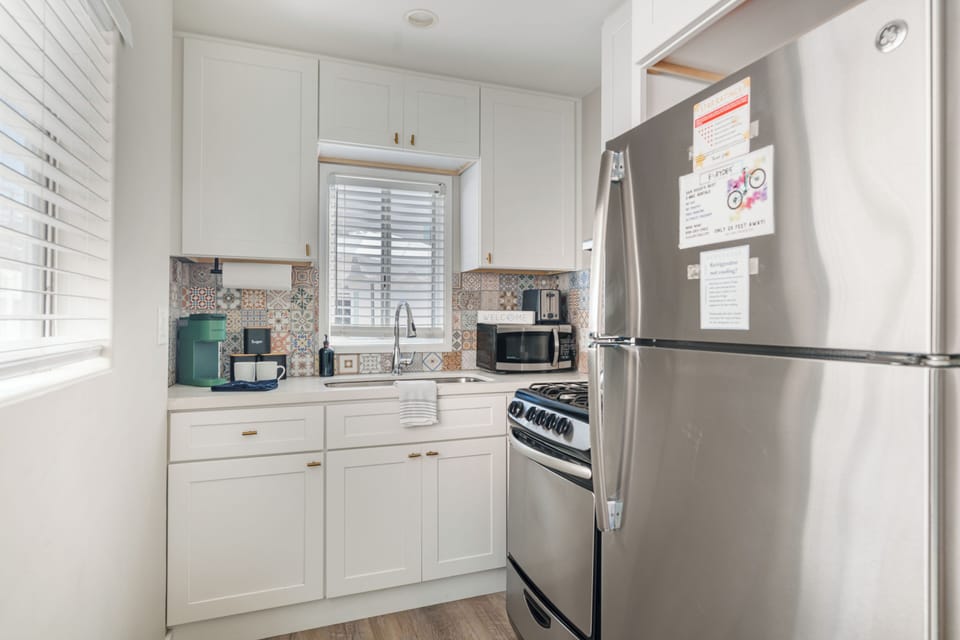 A sleek, full kitchen setup featuring stainless steel appliances and ample cabinetry.