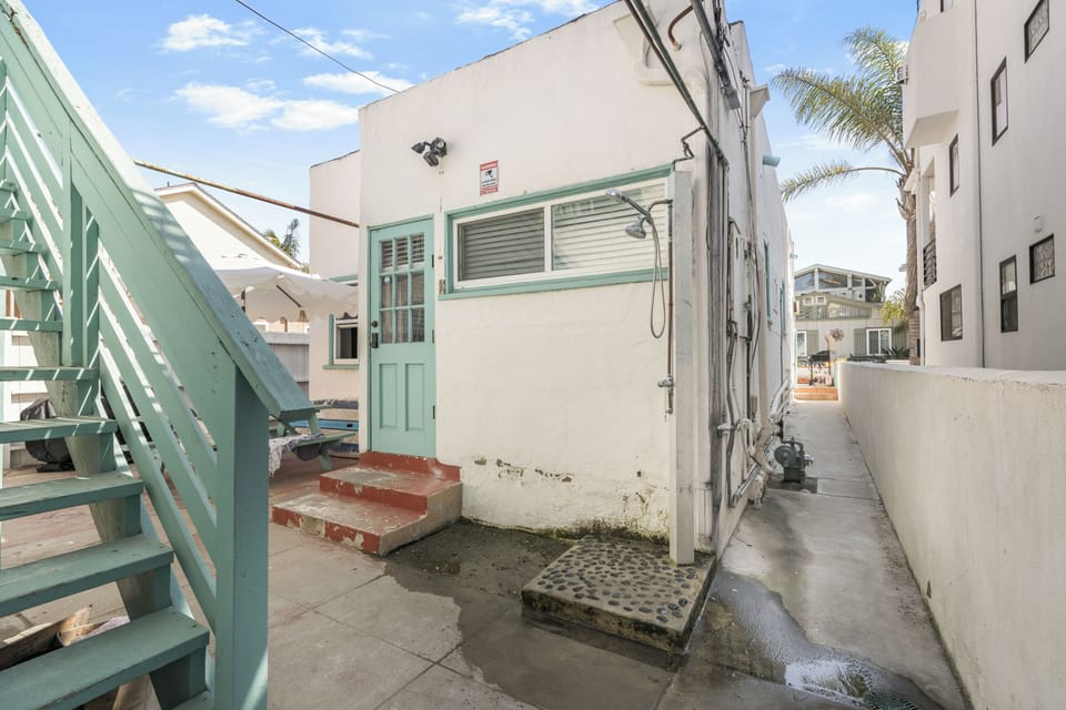 Shared patio with a BBQ grill and al fresco dining table.