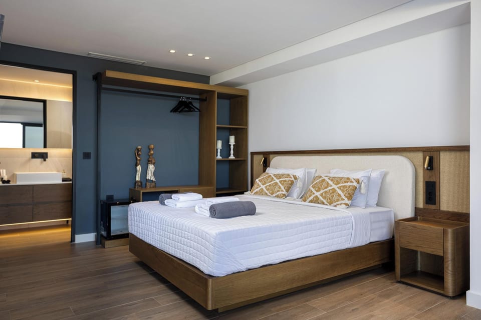 It also features an open closet with a safe deposit, a mini fridge, blackout curtains, a 43” TV, and direct access to the pool area.
