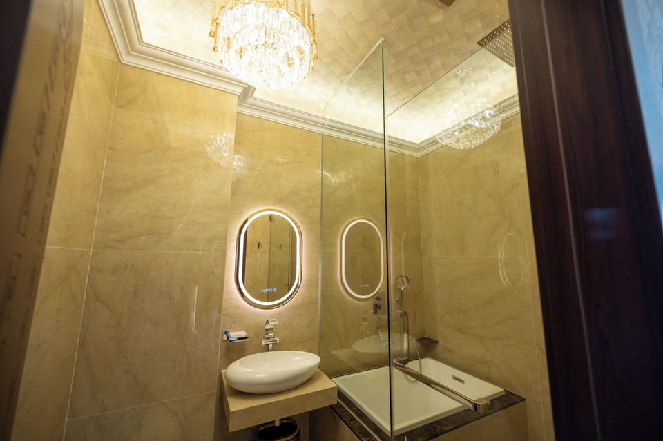 Deluxe Room, 1 King Bed, City View | Bathroom | Separate tub and shower, rainfall showerhead, designer toiletries