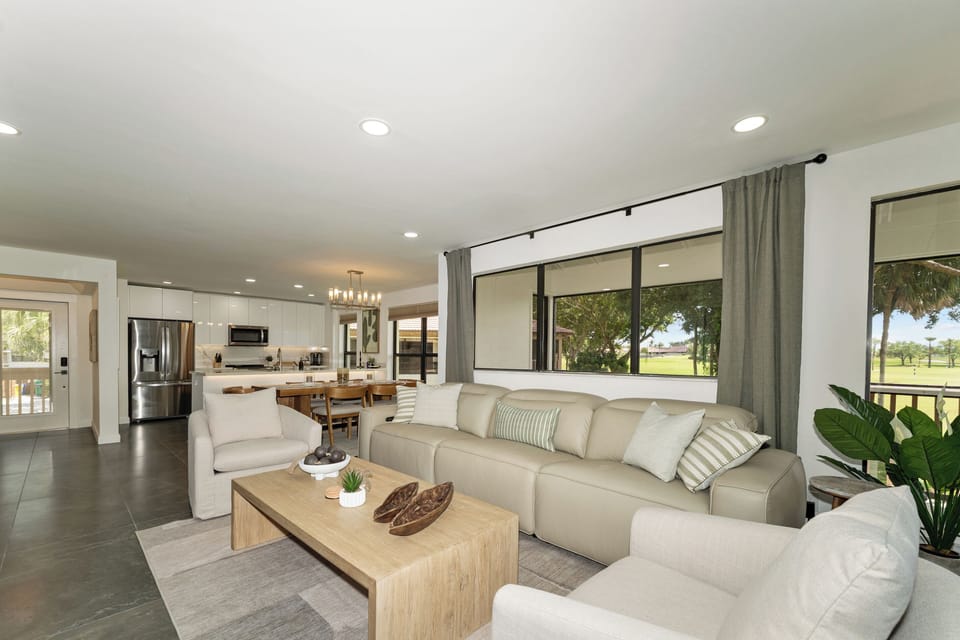 Seamless indoor-outdoor feel with large windows overlooking the fairway