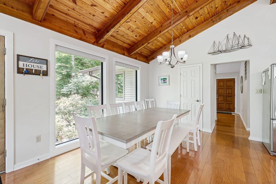 A massive family dining table featuring plenty of seating, including a kid-friendly bench.