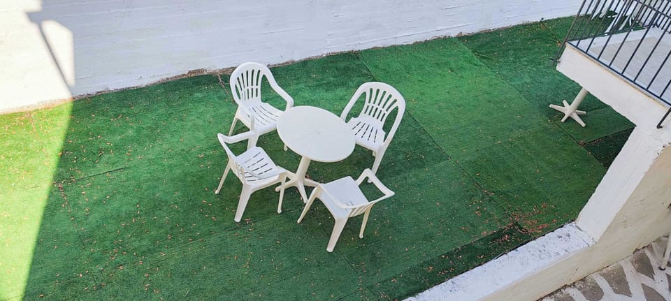 Shared outdoor patio with seating on artificial grass