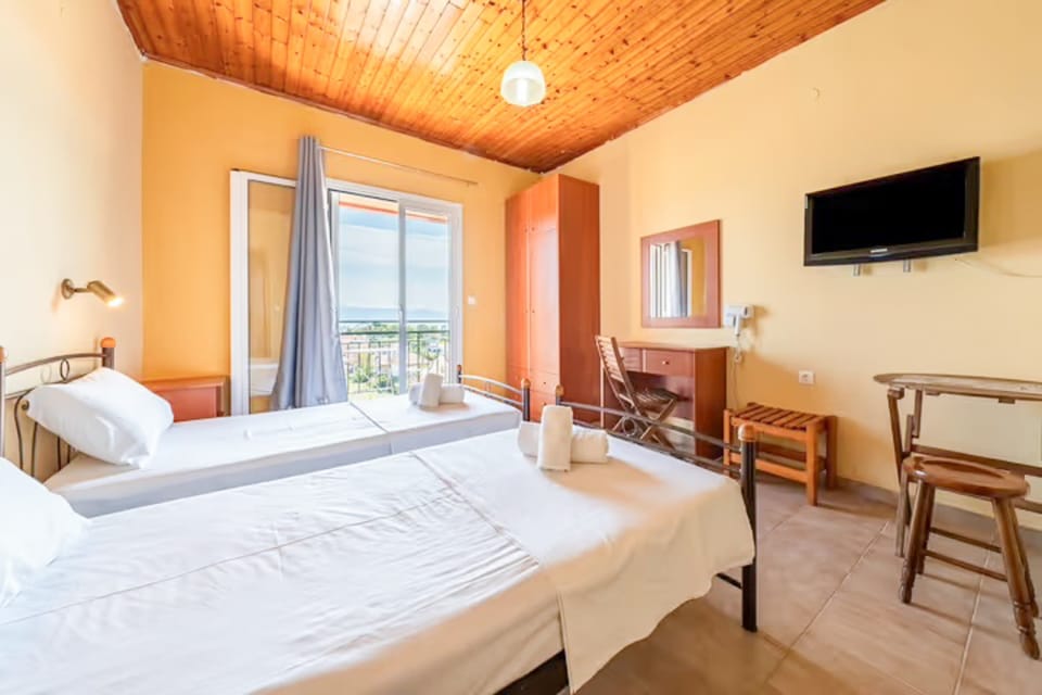 Relax in a cozy space with TV and easy access to the balcony.