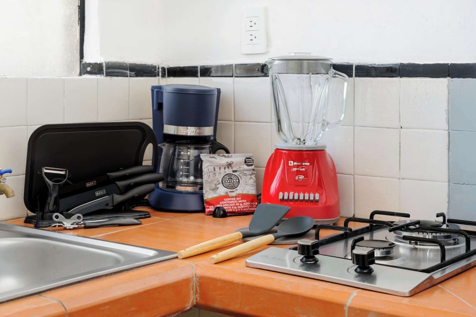 Kitchen equipped with stove, blender, coffee maker and more