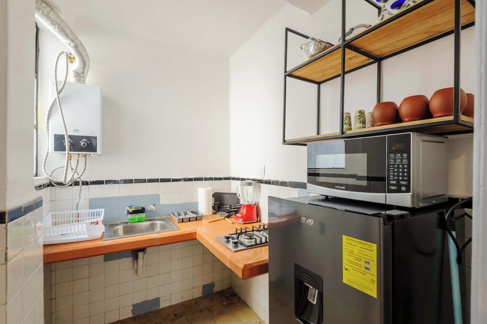 Fully equipped kitchen with fridge, stove, and microwave