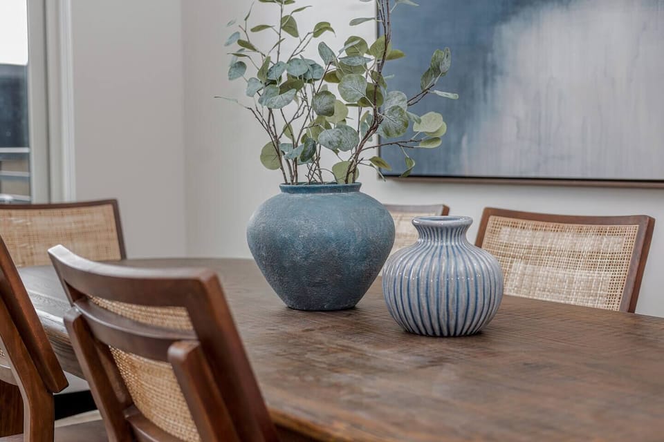 Dining Room: Gather around a stylish table adorned with artistic vases and natural greenery!