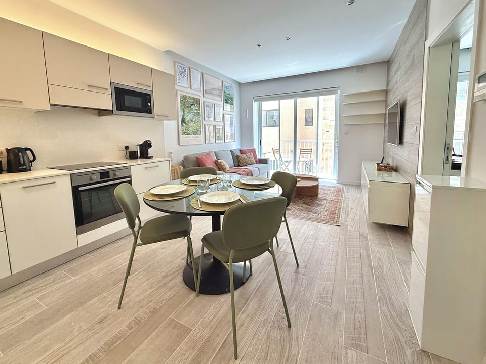 Kitchen area equipped with a refrigerator, electric cooker, oven, kettle, toaster, coffee machine, dishwasher and microwave.