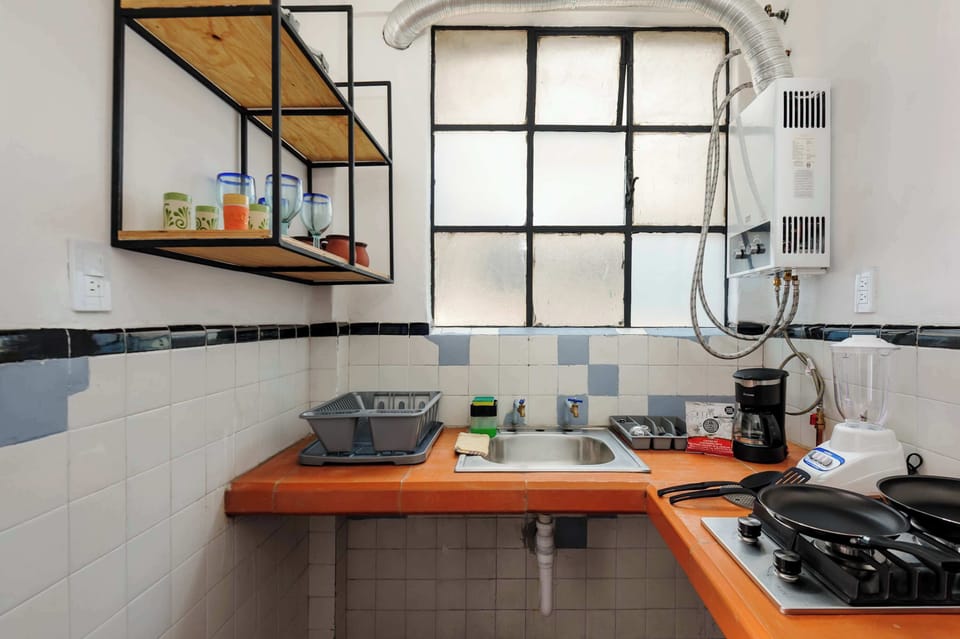 Kitchen with fridge, stove, microwave, coffee maker and more
