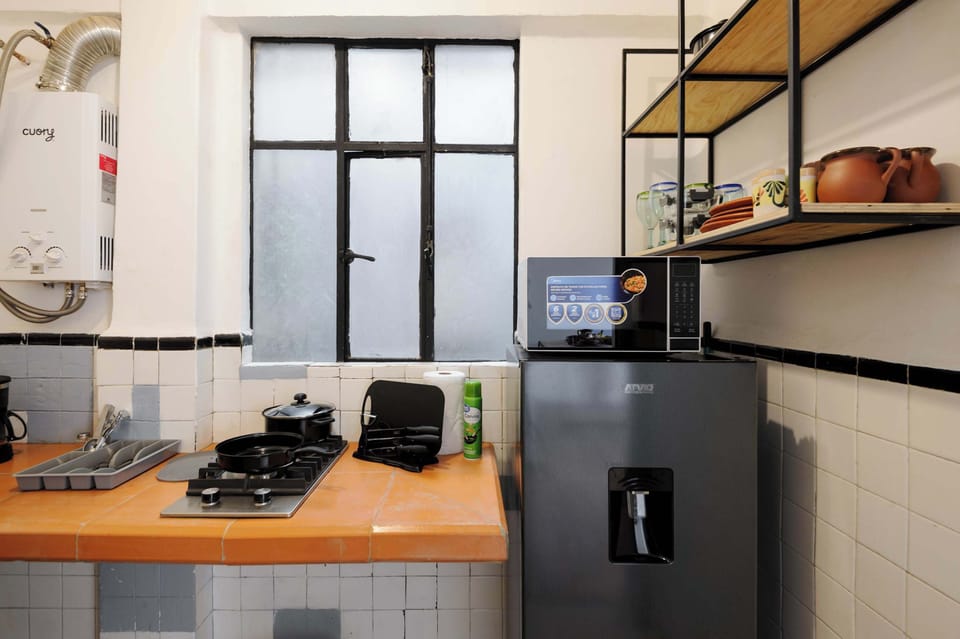 Kitchen equipped with fridge, microwave, stove and more