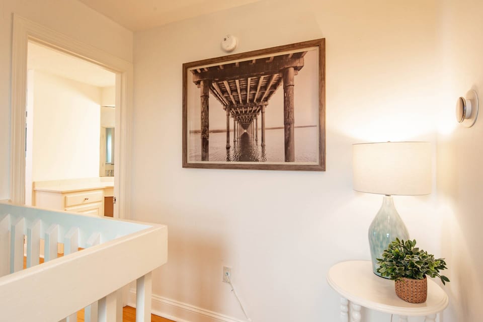 This hallway upstairs separates the primary suite from the guest suite.