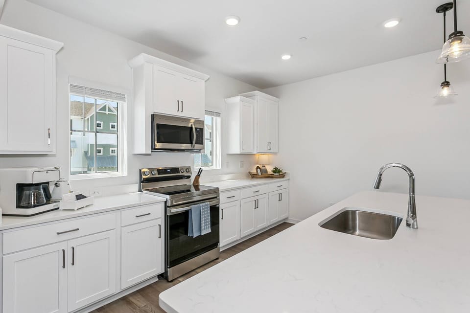 The kitchen is fully stocked with dinner and glassware, cutlery and chef's knives, Cuisinart cookware, small appliances, bakeware, and food storage