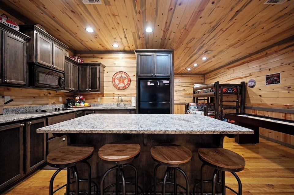 Your rustic kitchen features granite countertops, custom cabinetry, and a spacious island perfect for gathering with friends and family.