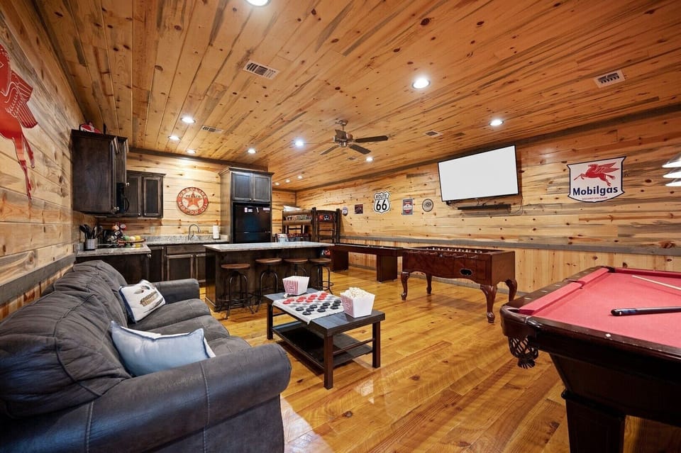 Your ultimate entertainment retreat awaits—sink into plush seating while enjoying pool, games, and your favorite shows in this warmly appointed rustic den.