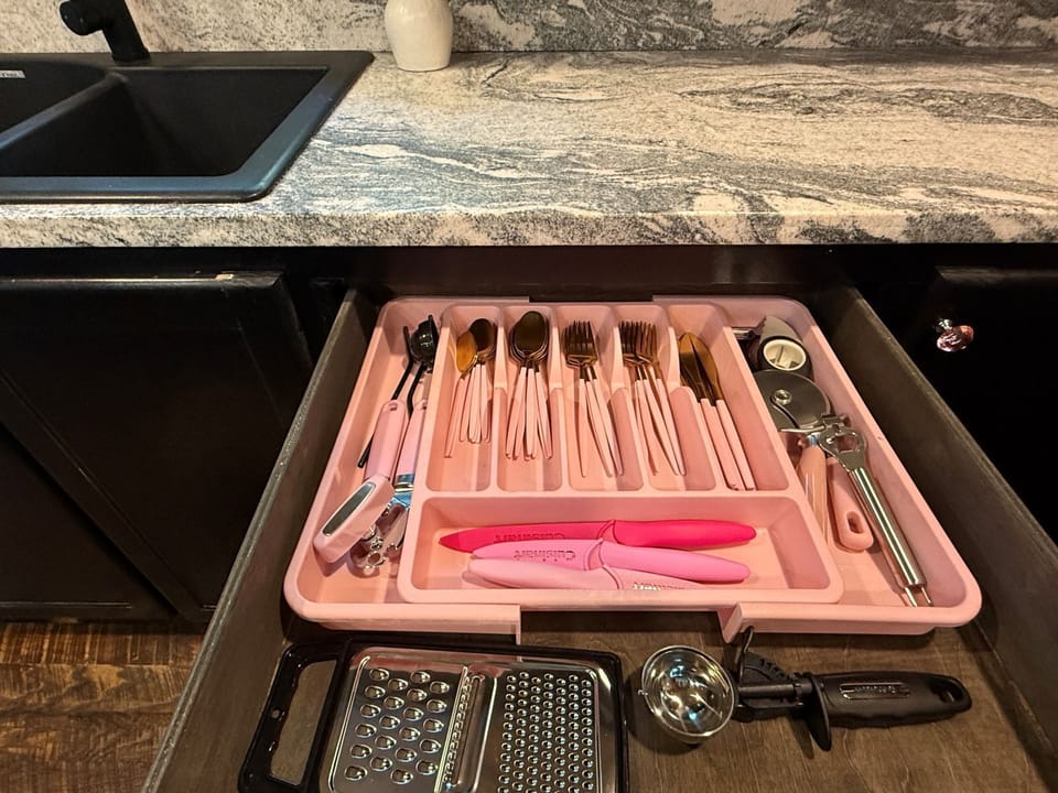 Open the drawer to find utensils perfectly organized, graters ready for meal prep, and a can opener at hand—your kitchen essentials right where you need them.