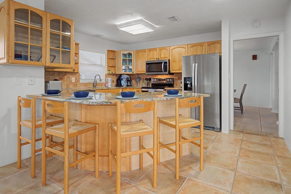 Gather around the spacious kitchen island where your group can cook together and share meals in this fully-equipped culinary haven.