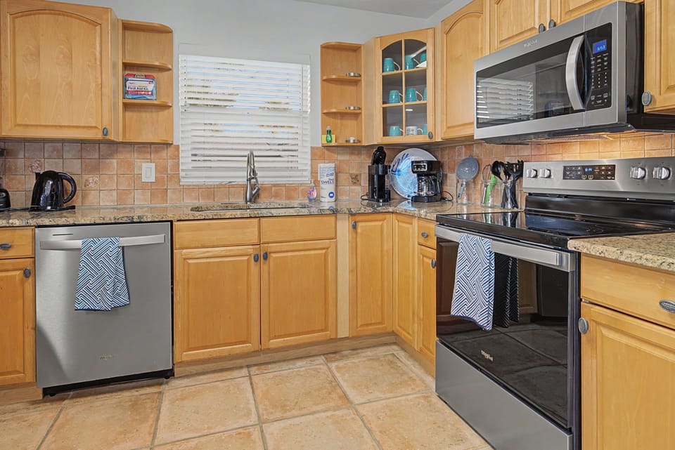 Cook your favorite meals in this spacious kitchen with granite counters, stainless steel appliances, and all the essentials you need.