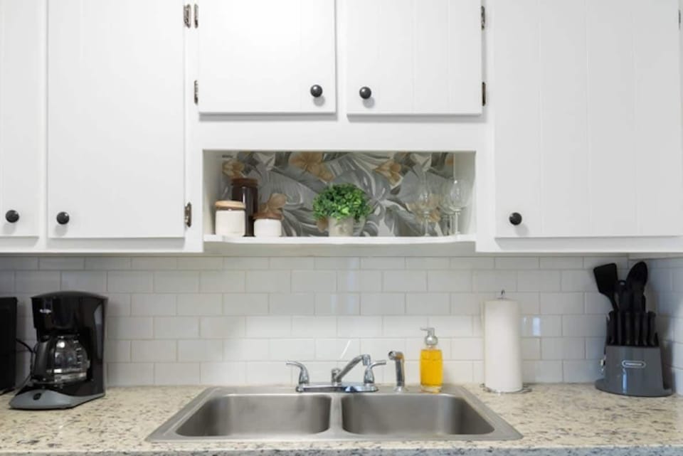 Sink area with white cabinets