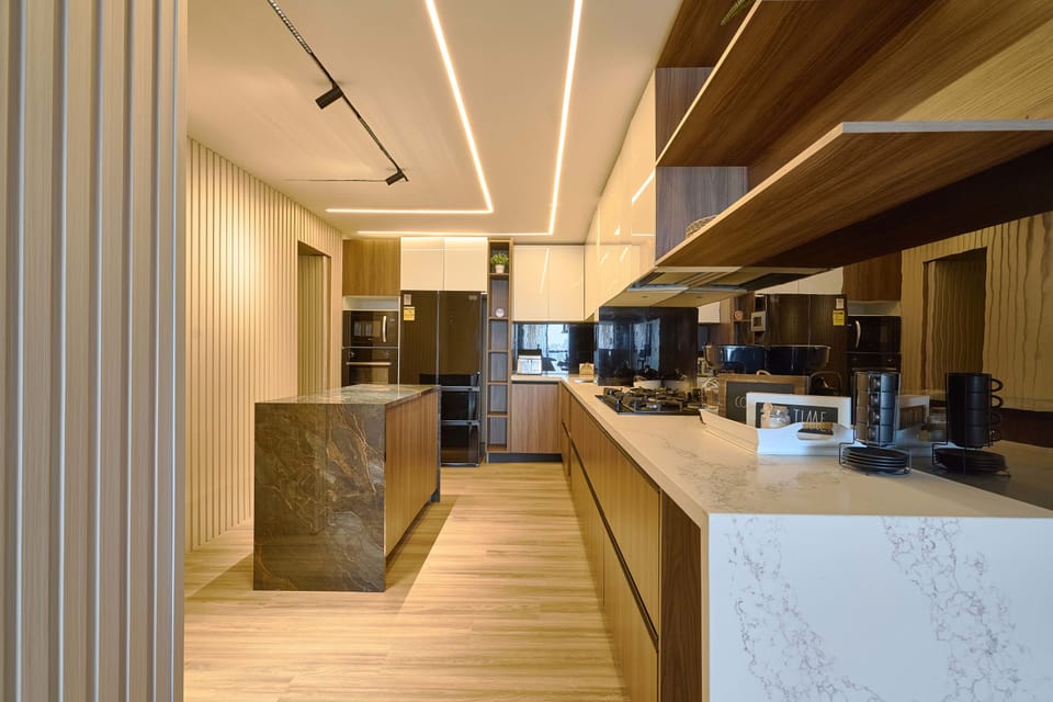 Fully equipped with stainless steel appliances, an American-style fridge, granite countertops, and a breakfast island—this kitchen is ready for culinary creations.
