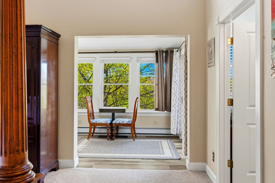 Cozy breakfast nook with serene tree views, perfect for your morning coffee or quiet moments throughout your stay.