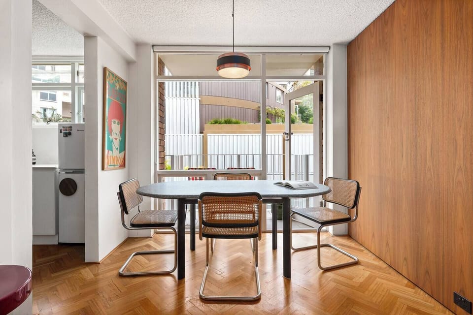 Light-filled dining area opening onto a private balcony with peaceful outlooks—ideal for morning coffee or relaxed dinners.