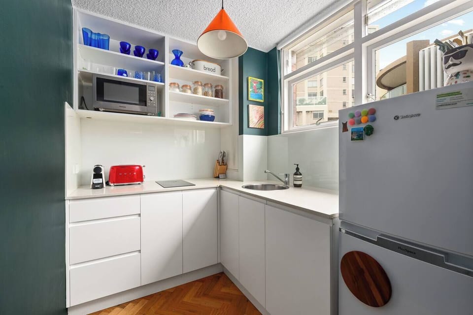 A neat, well-equipped kitchen with modern appliances and a fresh, functional layout—perfect for easy meals at home.