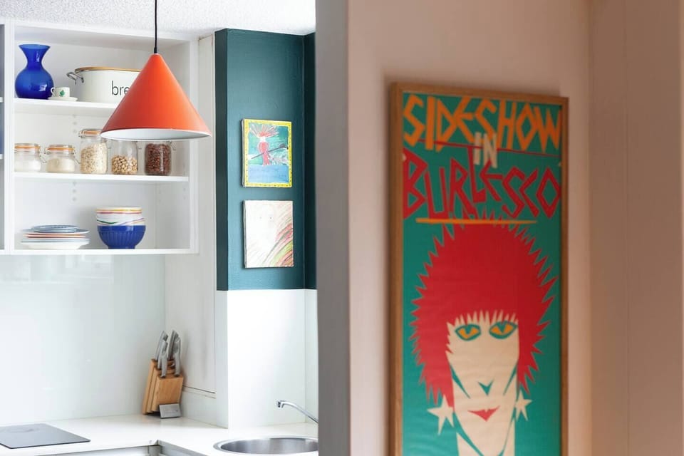 Thoughtful design touches and vibrant accents bring character to this clean, contemporary kitchen space.