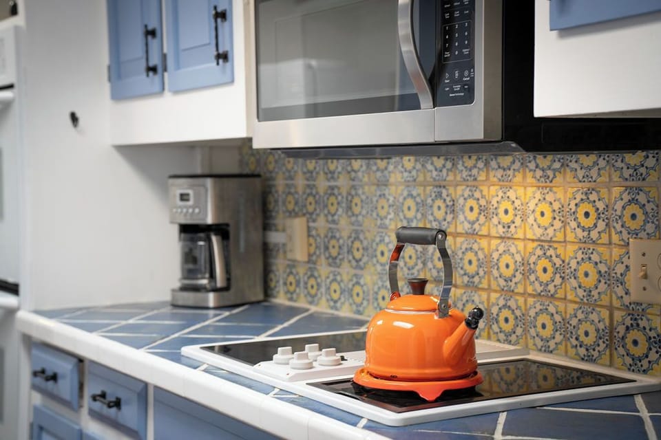 Your bright kitchen awaits with charming tile backsplash and modern appliances for easy meal preparation during your stay.