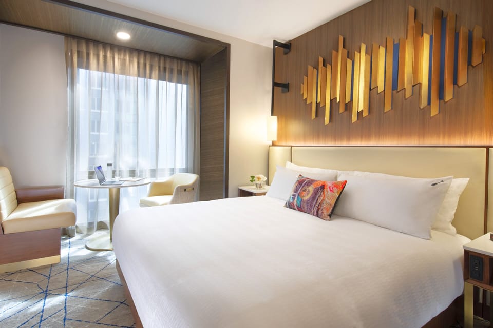 Recharge in a serene king room with sunny window desk.