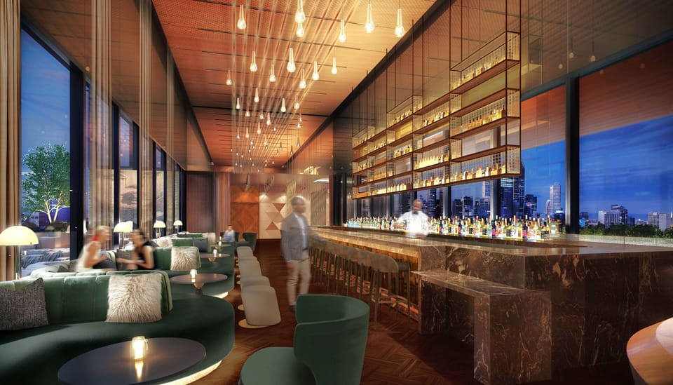 Sip cocktails as city lights sparkle beyond the rooftop bar.