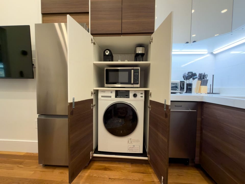 Convenient in-suite laundry with modern built-in design