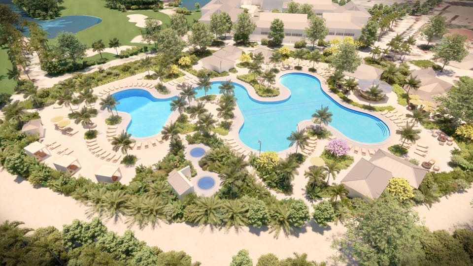Explore the expansive resort pool complex from above in daylight.