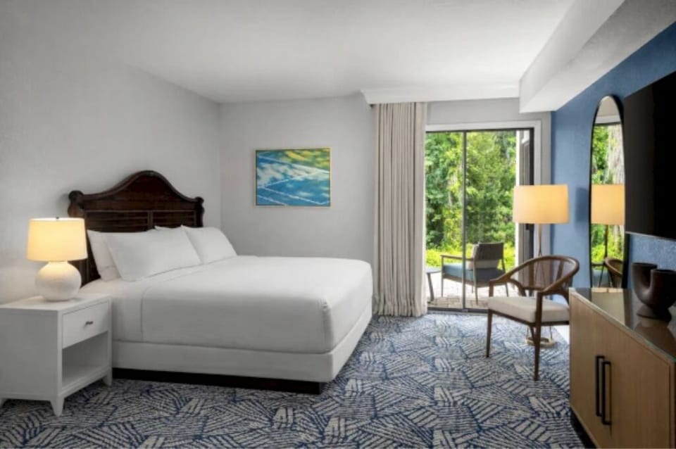 Drift off in a plush king with lush outdoor scenery.