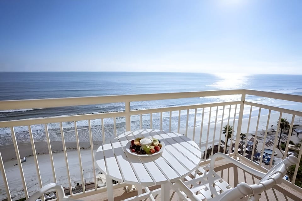 Sip morning coffee on the balcony above sparkling waves.