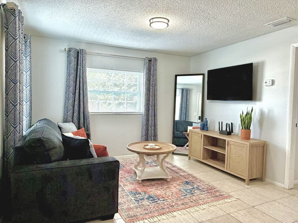 Stylish living room with smart TV and queen sleeper sofa for extra accommodations.