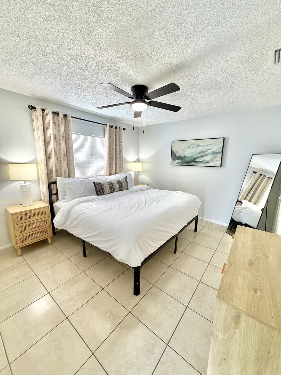 Spacious king suite featuring a plush bed, smart TV, and private ensuite bathroom. Thoughtfully designed with convenient USB charging ports on each nightstand, so everything you need is right within reach.