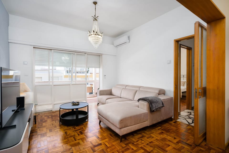 Bright living area with a flat-screen TV and direct access to the balcony.