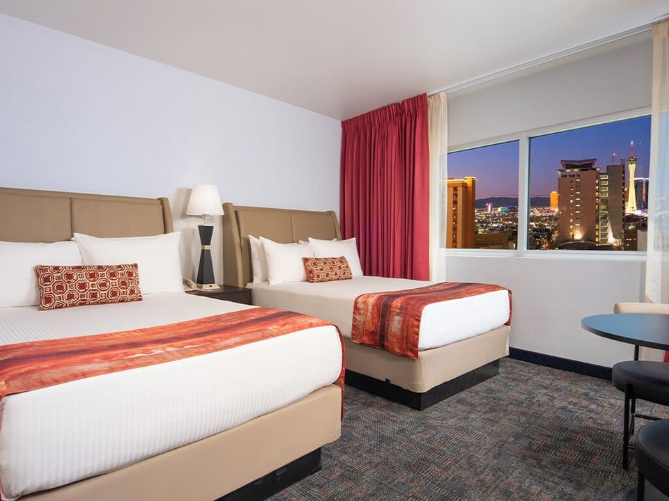 Wake up to sunlit comfort beside expansive picture windows.