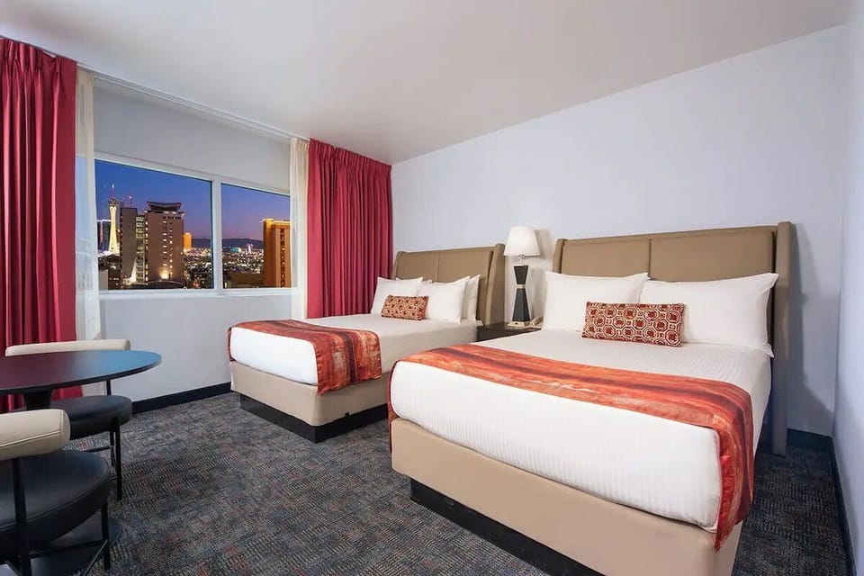 Unwind in plush beds with sparkling city skyline views.